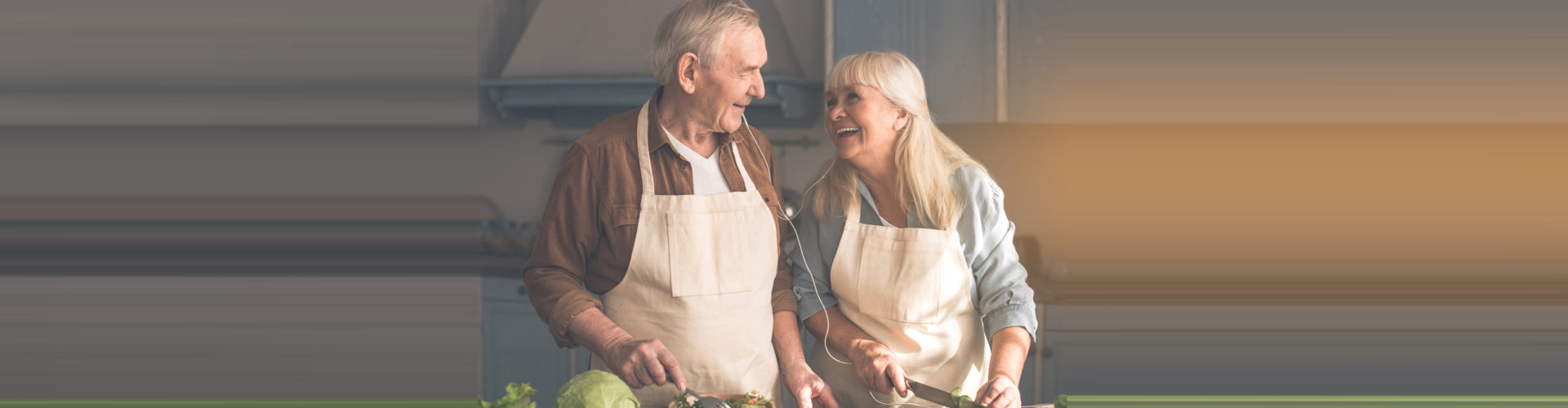 happy elderly couple preparing food